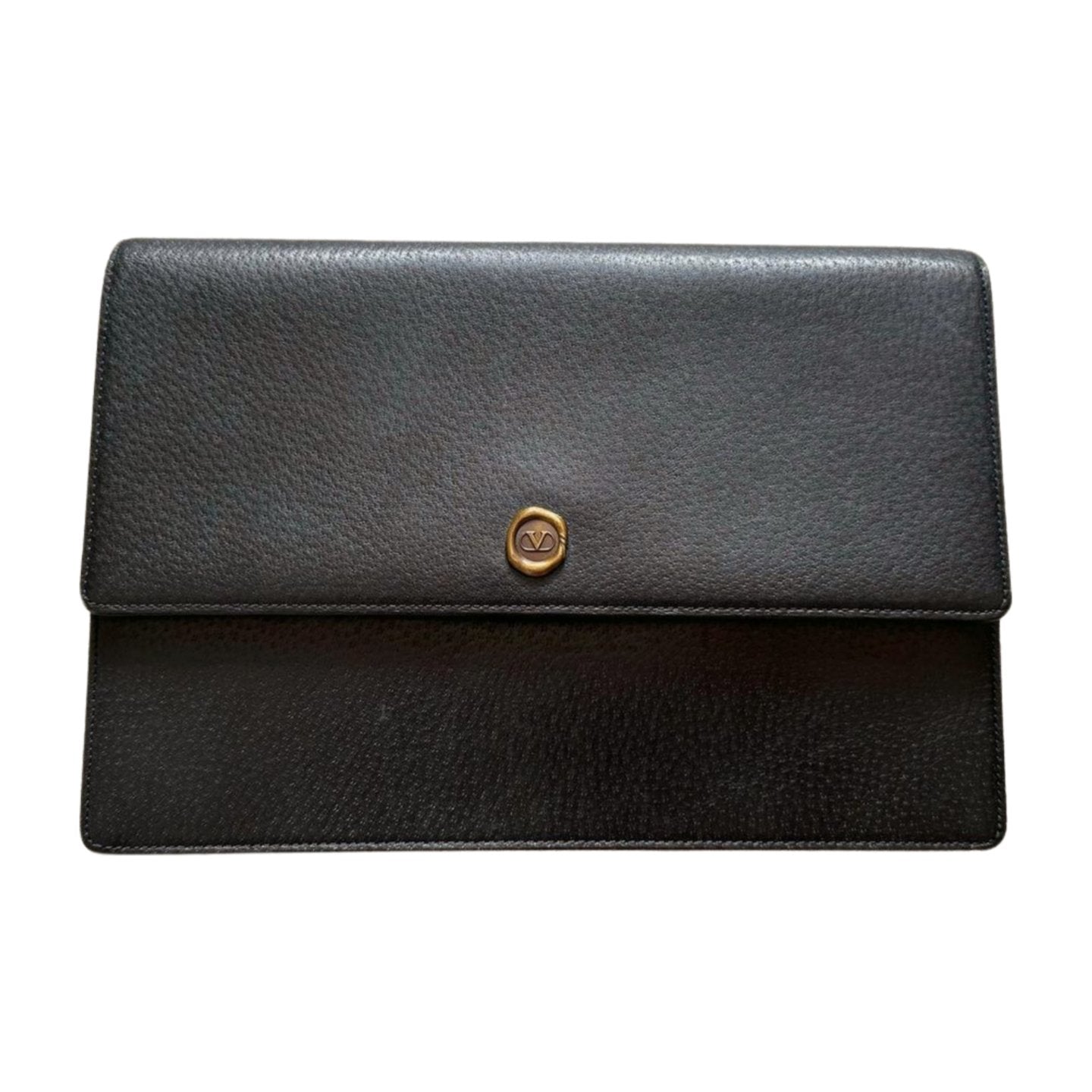 A sleek black grained leather clutch bag with a textured finish. It features a gold circular emblem with the letters "VD" in the center on the front flap. This Valentino Garavani Valentino Black Leather Clutch comes with its original Valentino dust bag, adding to its minimalist and elegant design.