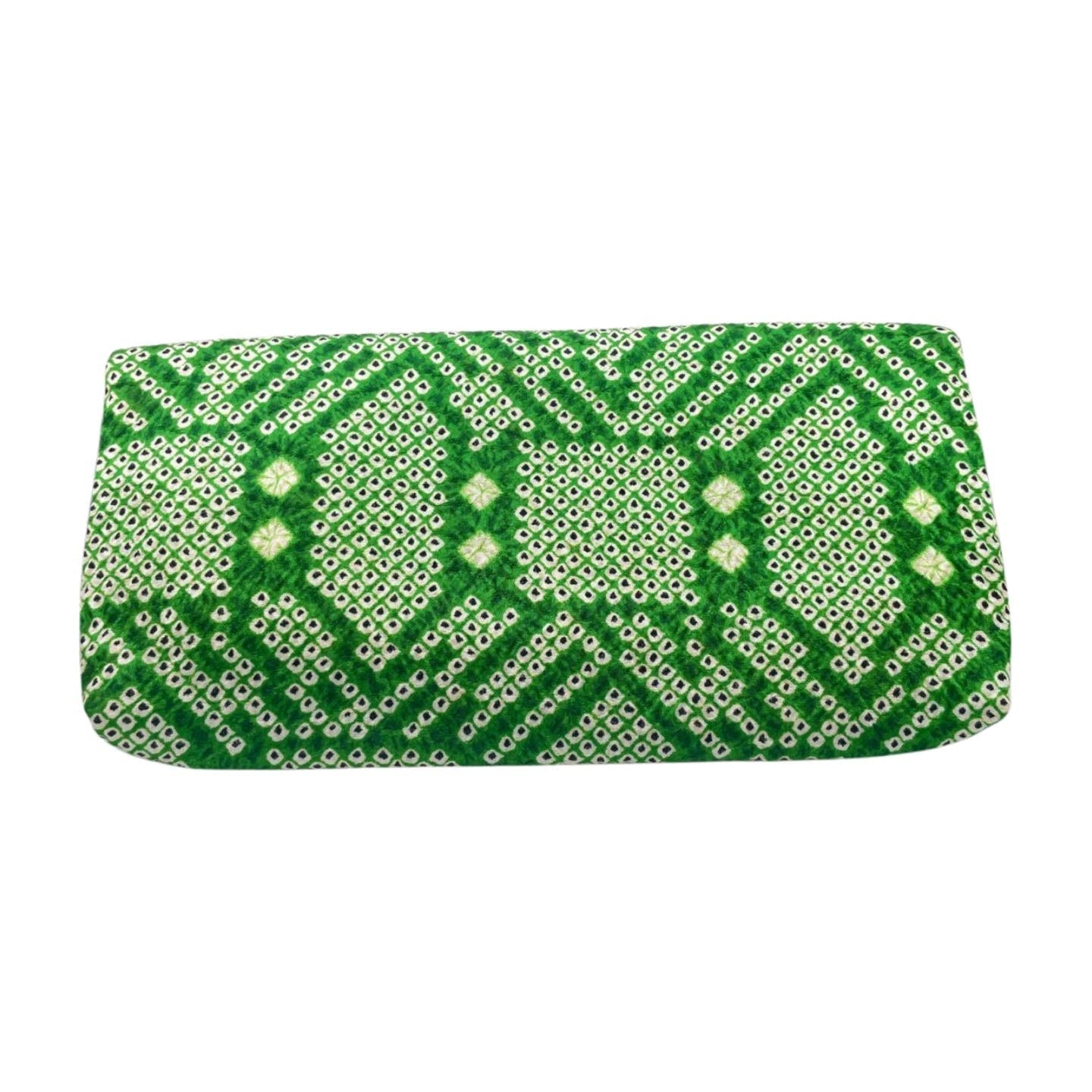 A Vintage 1970's Green Clutch by Vintage, featuring a green and white rectangular design with a geometric pattern. The intricate design includes small circular and diamond shapes, creating a repeating, symmetrical motif. Crafted from crinkled silk, the clutch has a textured fabric appearance and boasts a secure clasp closure.