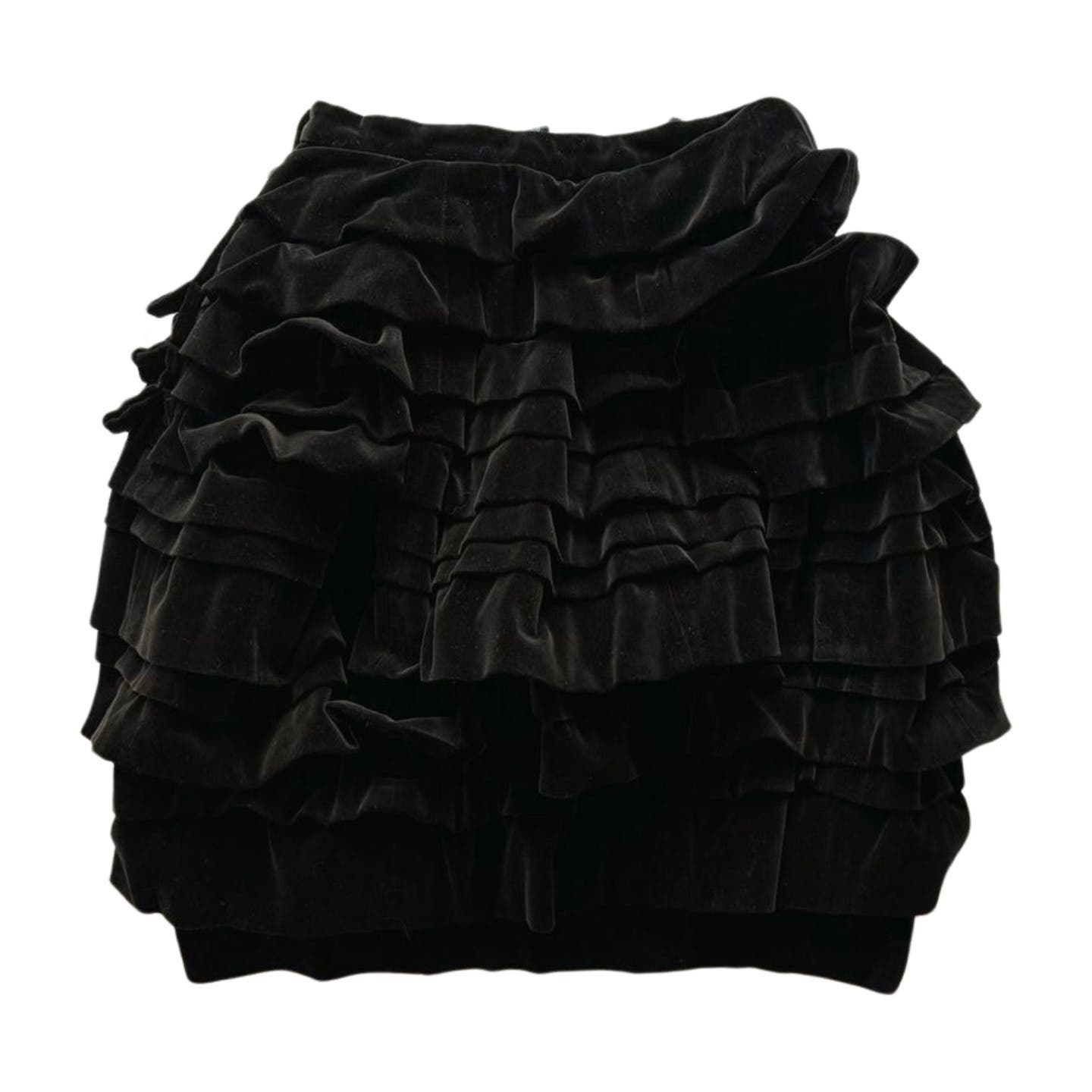 A black velvet mini skirt with multiple layers of ruffled fabric creating a voluminous effect. Reminiscent of 90s Comme des Garçons, the Vintage 1990 Comme des Garcons Skirt features horizontal pleats and a slightly flared silhouette. The waistband appears fitted without any visible closures, giving it a vintage condition vibe.
