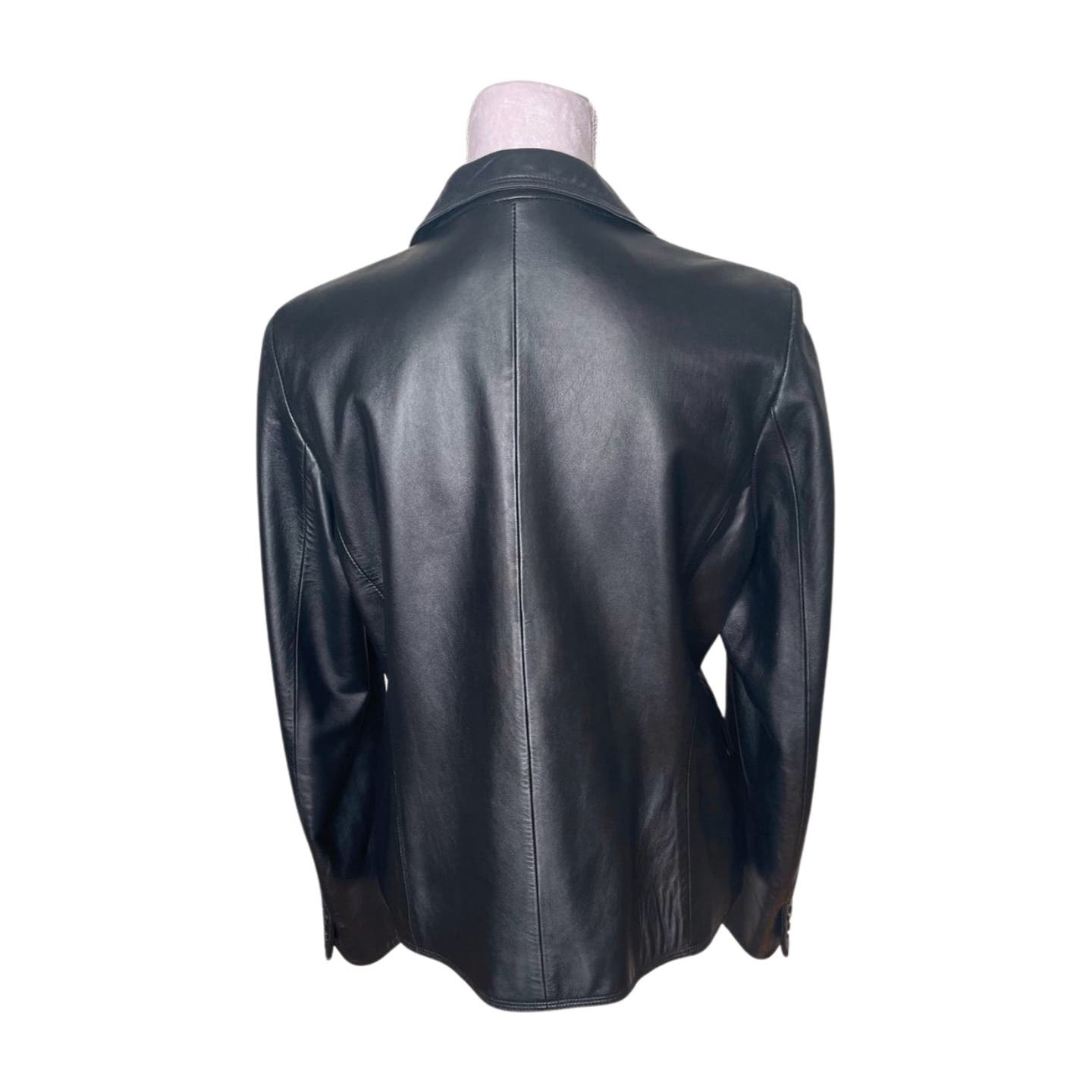 A Vintage Balmain Black Leather Blazer from Balmain is shown from the back. It has a smooth texture, long sleeves, a collar, and button details on the cuffs. The blazer extends to hip length and features a sleek, tailored design with a polyester lining. Professional cleaning is recommended to maintain its pristine condition.